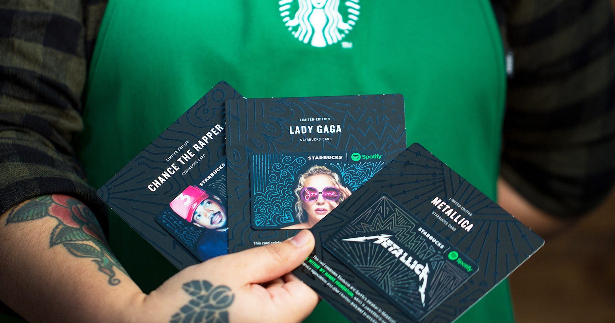 Starbucks barista holding limited edition Spotify cards